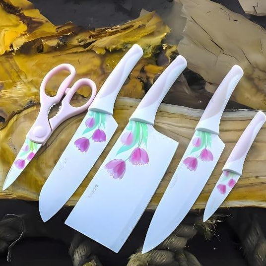 Set of ceramic knives with floral designs on wooden surface
